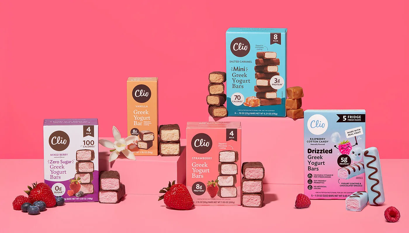Clio Greek yogurt bar packages with berries and bars on a pink background