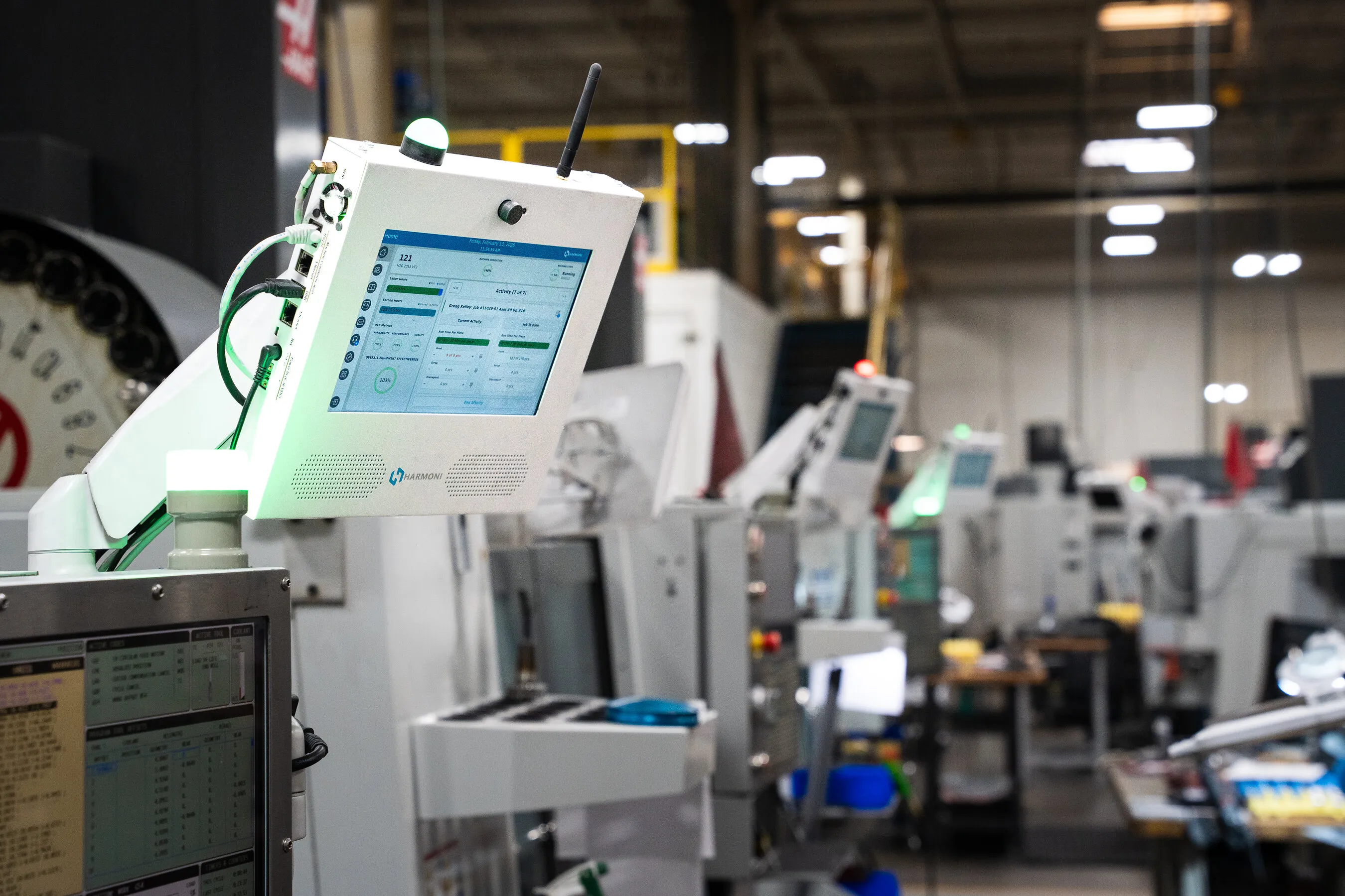 Industrial machines with touchscreen control panels in a factory.
