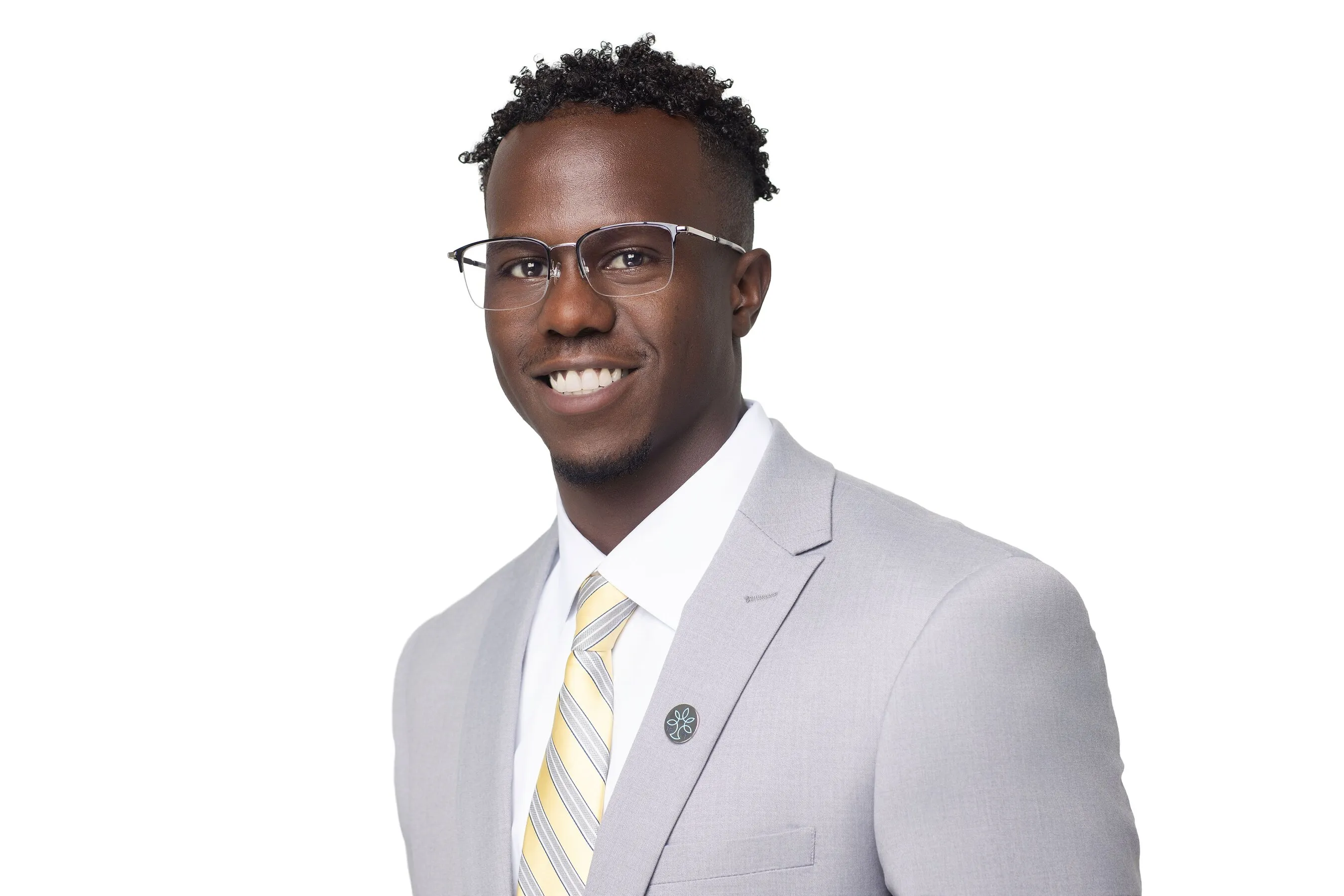 Tim C. Valentine wearing glasses and a light grey suit with a striped tie.