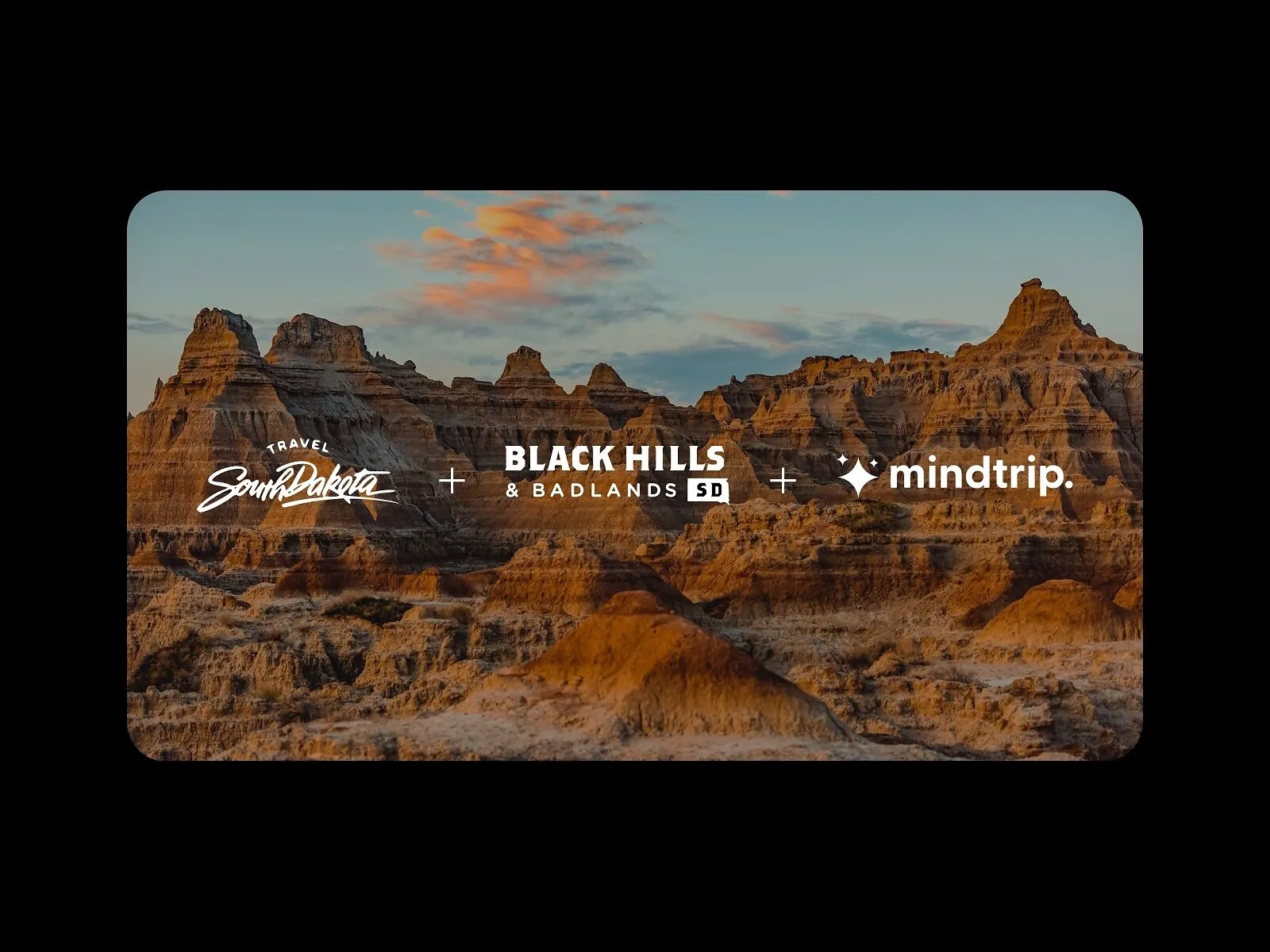 Travel South Dakota, Black Hills & Badlands and Mindtrip logos over Badlands rock formations at sunset
